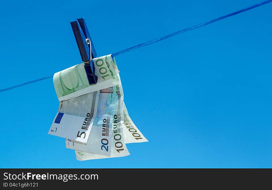 Euro money banknotes hanging on clothesline