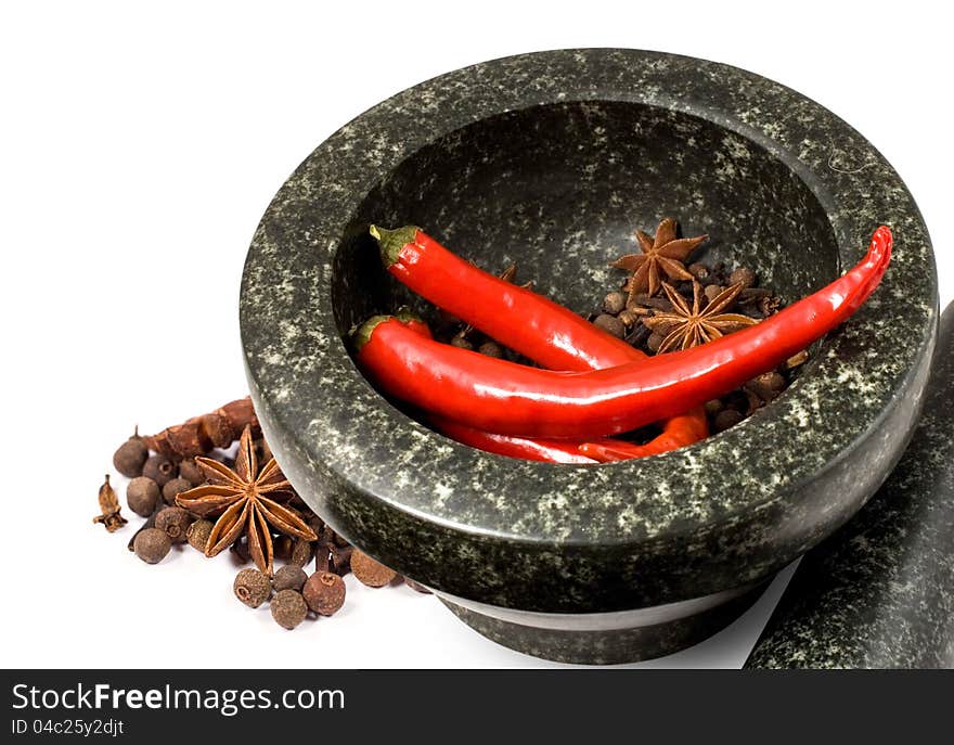 Stone mortar with spices and chilli