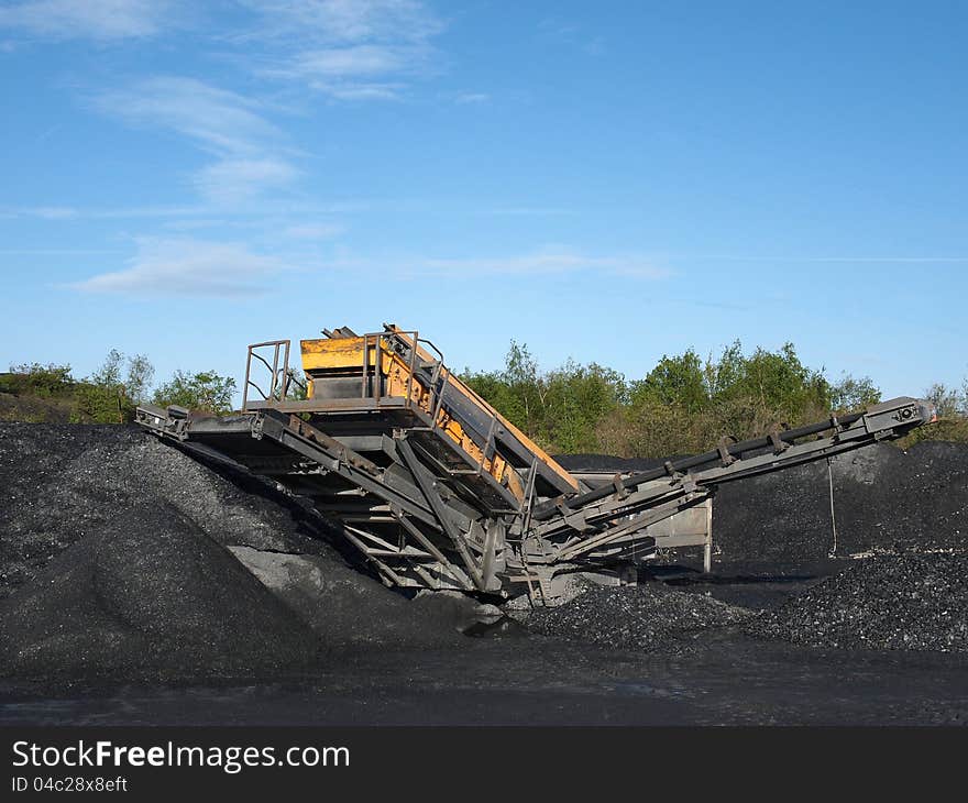 Crusher plant in a slate mine under a clear blue sky. Crusher plant in a slate mine under a clear blue sky.