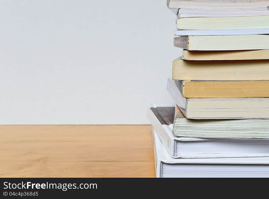 Part of paper book stack on wood table