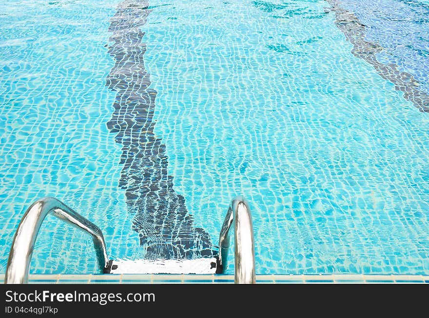 Stairway to swimming pool on aqua blue background