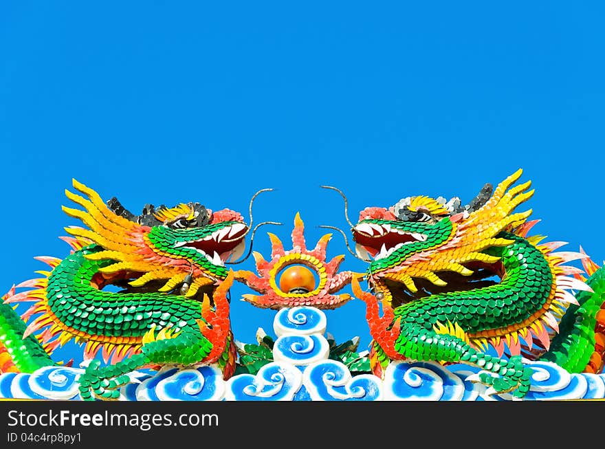 Colorful twin chinese dragon statue in clear blue sky. Colorful twin chinese dragon statue in clear blue sky