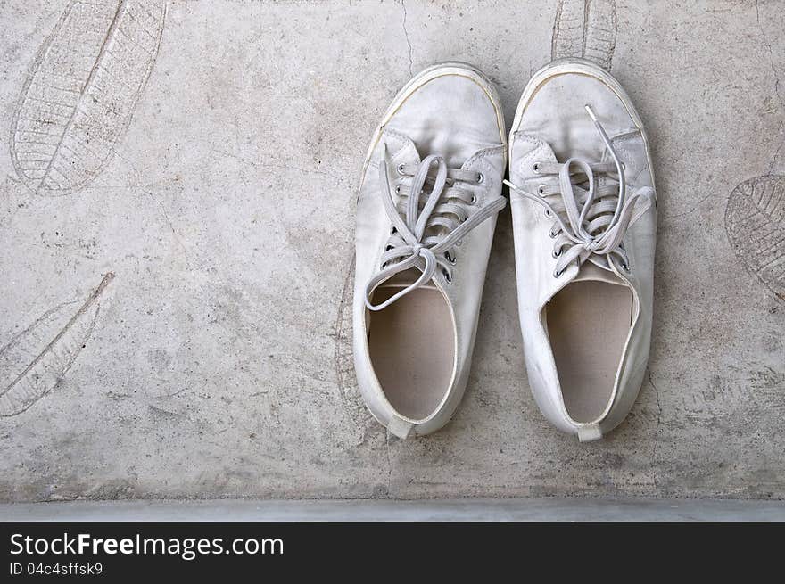 Old White Sneaker On Cement Floor