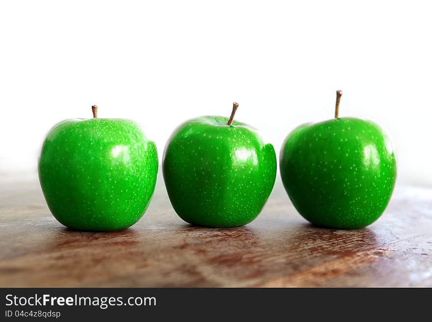 Fresh green apples on a wooden table. Fresh green apples on a wooden table.