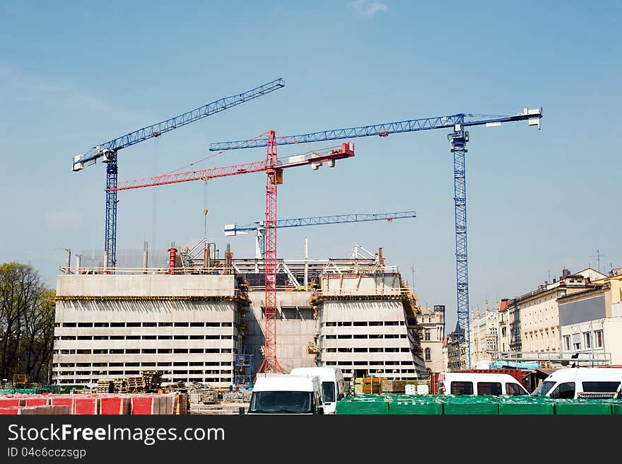 Construction cranes at big construction site in a city