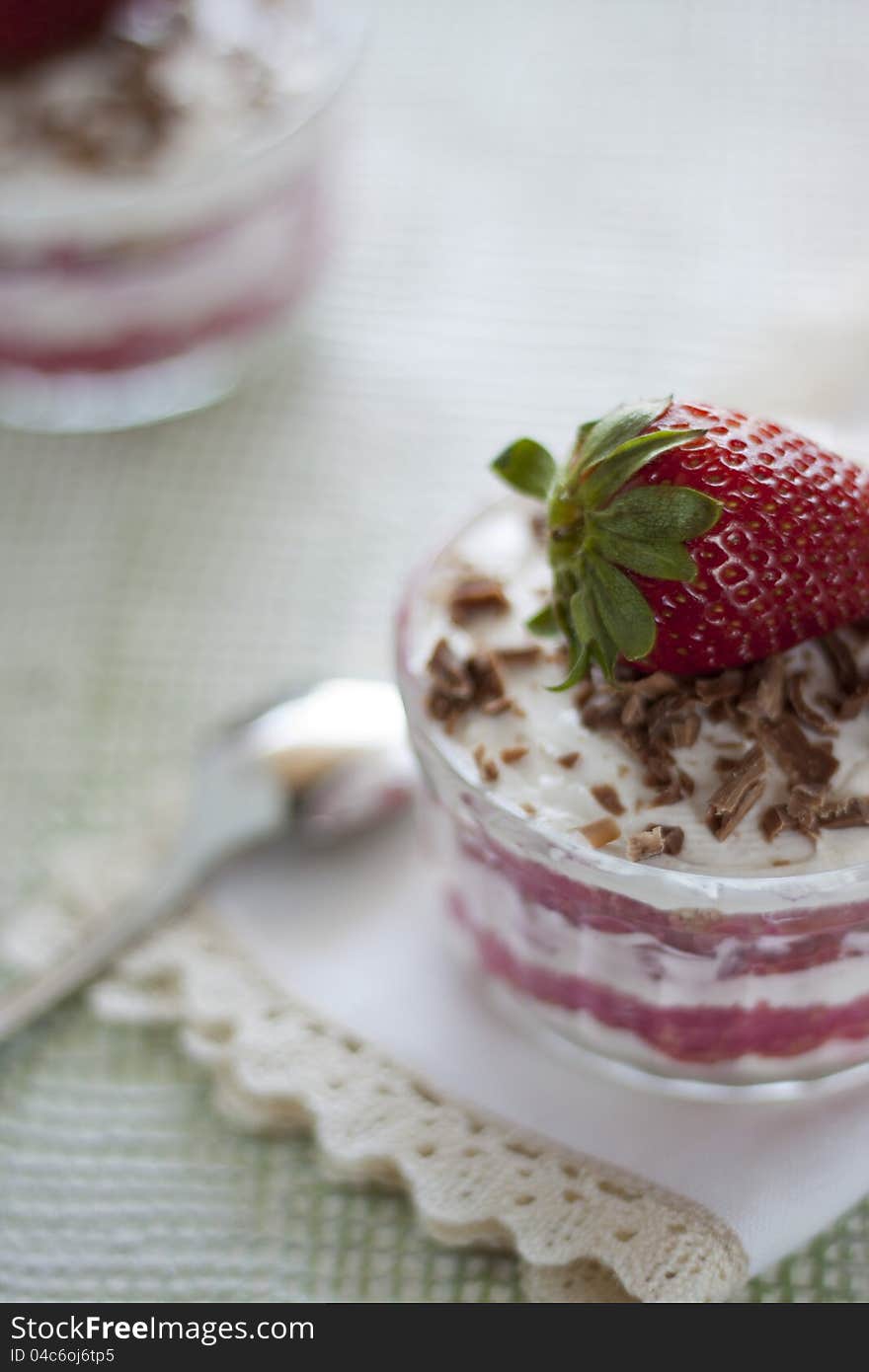 Dessert with sponge cake, whipped cream and strawberries. Dessert with sponge cake, whipped cream and strawberries