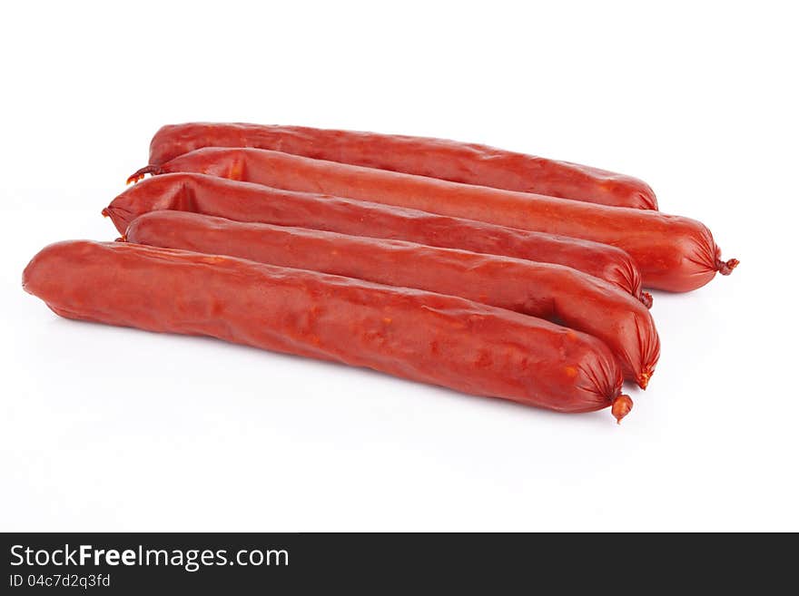 Raw red sausage on a white background