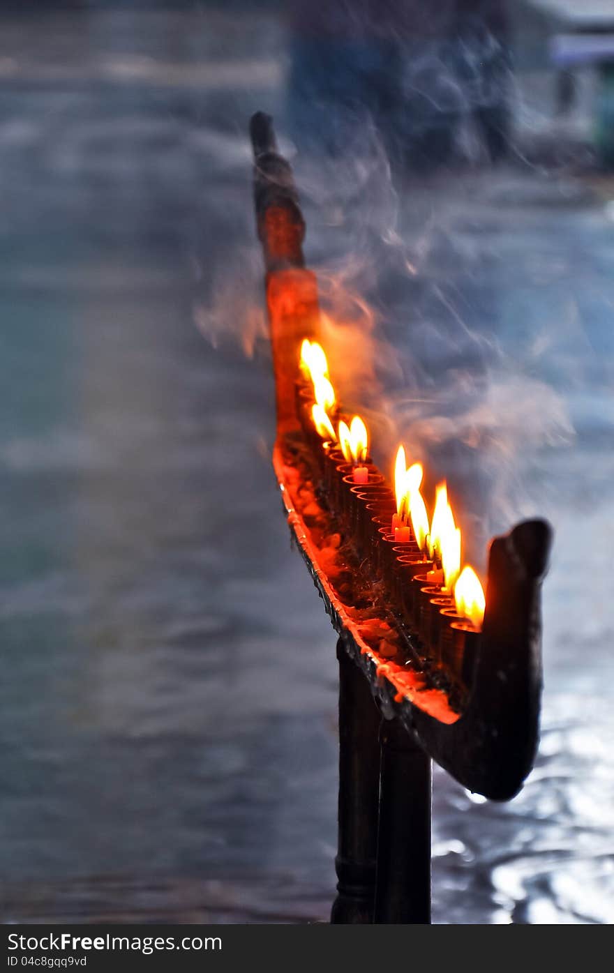 Flame and smok of the candle in Buddhist holy day