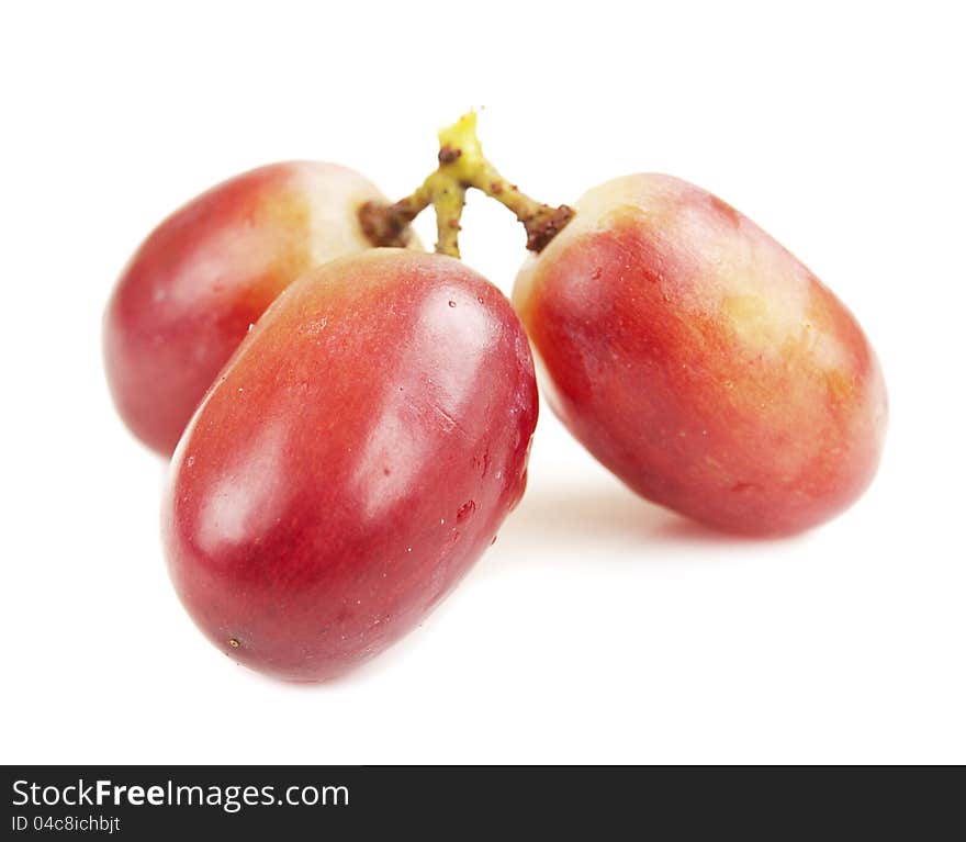 Red seedless grapes on a white background. Red seedless grapes on a white background