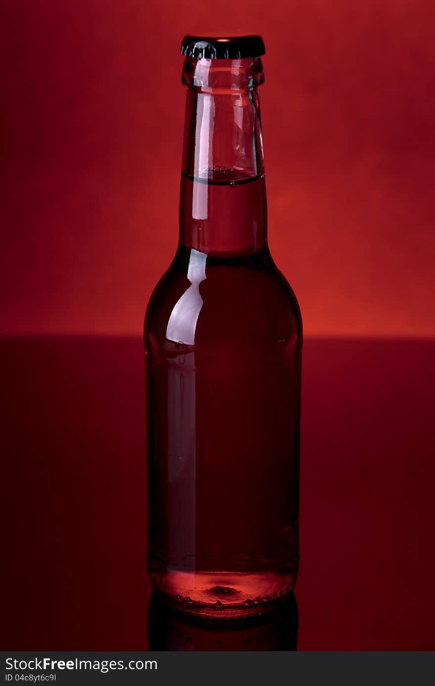 Glass bottle on a red background