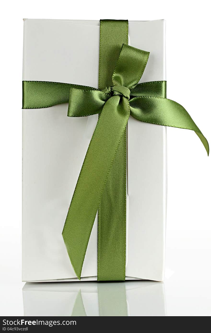 White cardboard box with a green ribbon. White cardboard box with a green ribbon.