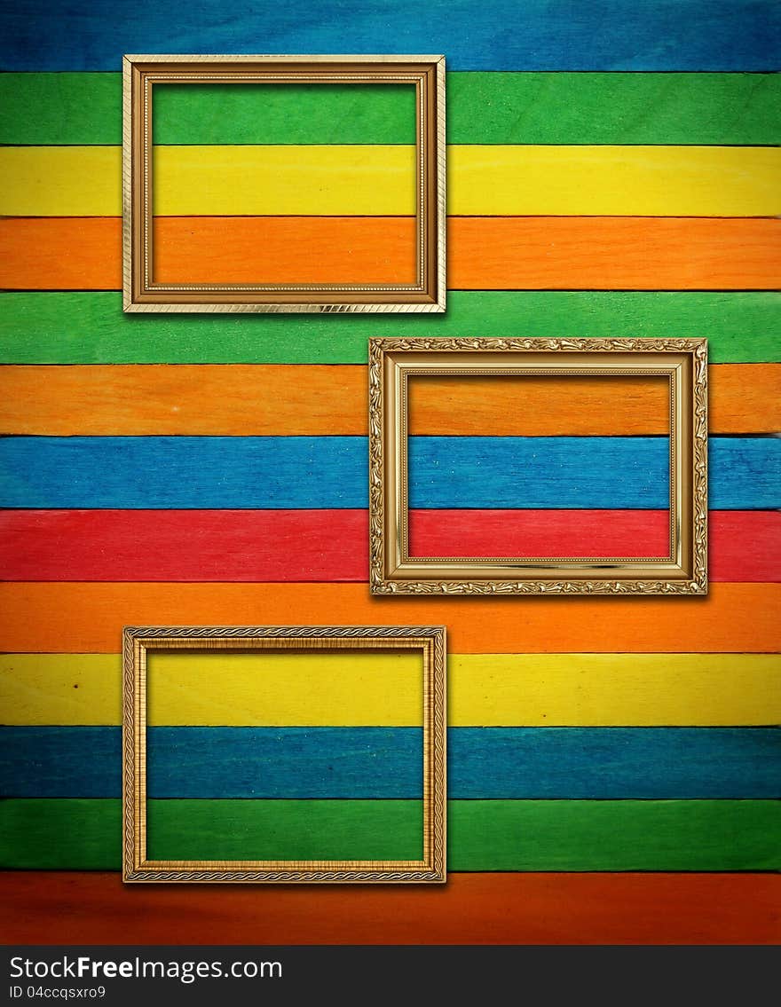 Gold frame on colorful wood