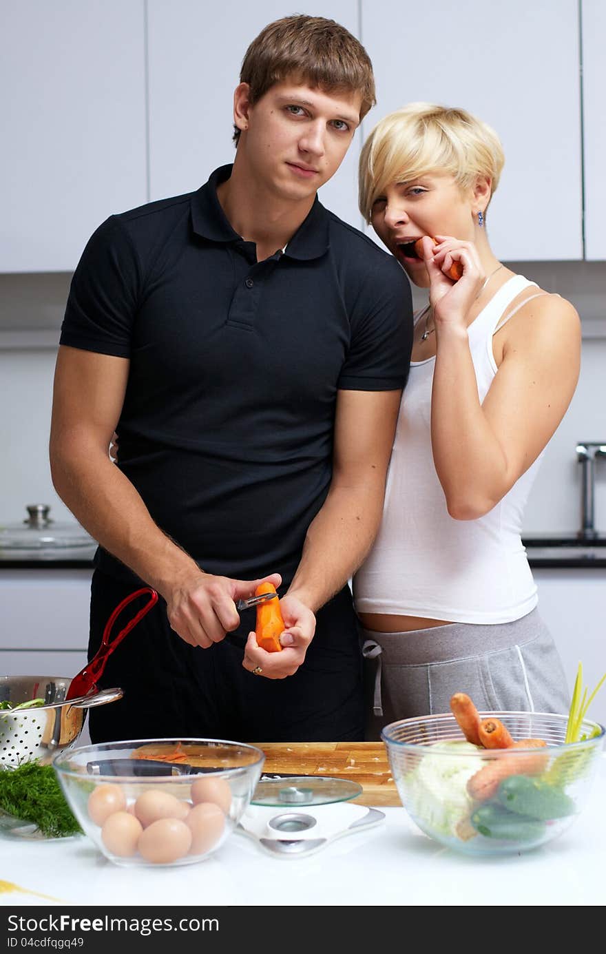 Couple in their kitchen making dinner