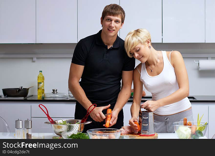 Couple in their kitchen making dinner