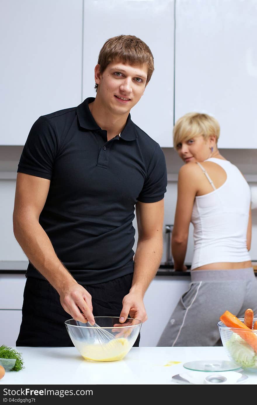 Couple in their kitchen making dinner