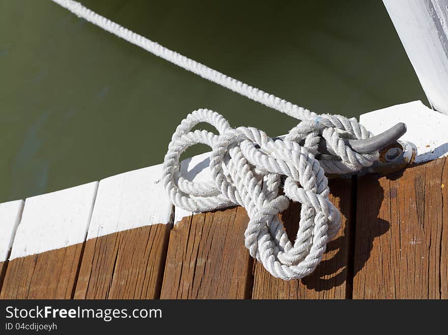 Rope on a post where the ship is tied up at the pier. Rope on a post where the ship is tied up at the pier