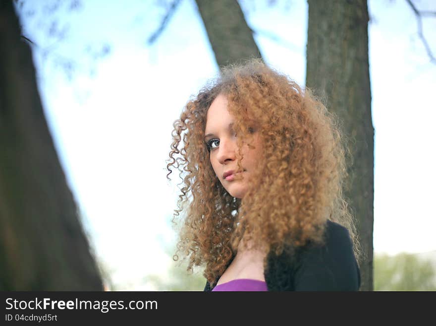 Portrait of a girl in the trees spring