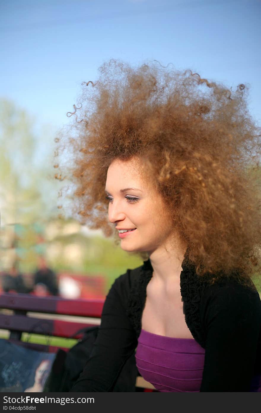 Portrait of curly pretty girl in the park. Portrait of curly pretty girl in the park