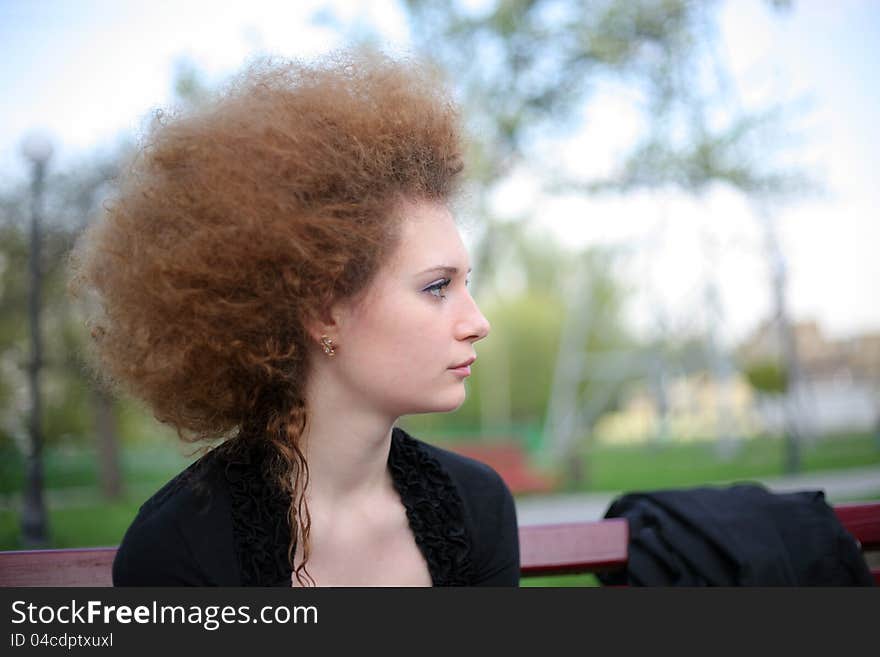 Portrait of curly girls side in the park. Portrait of curly girls side in the park