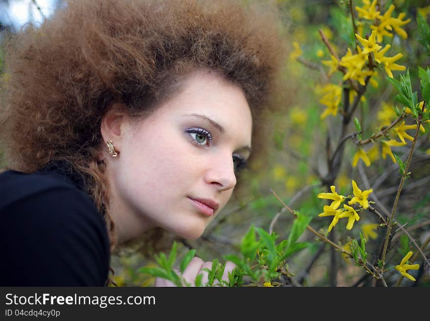 Portrait of a girl in nature with yellow flowers