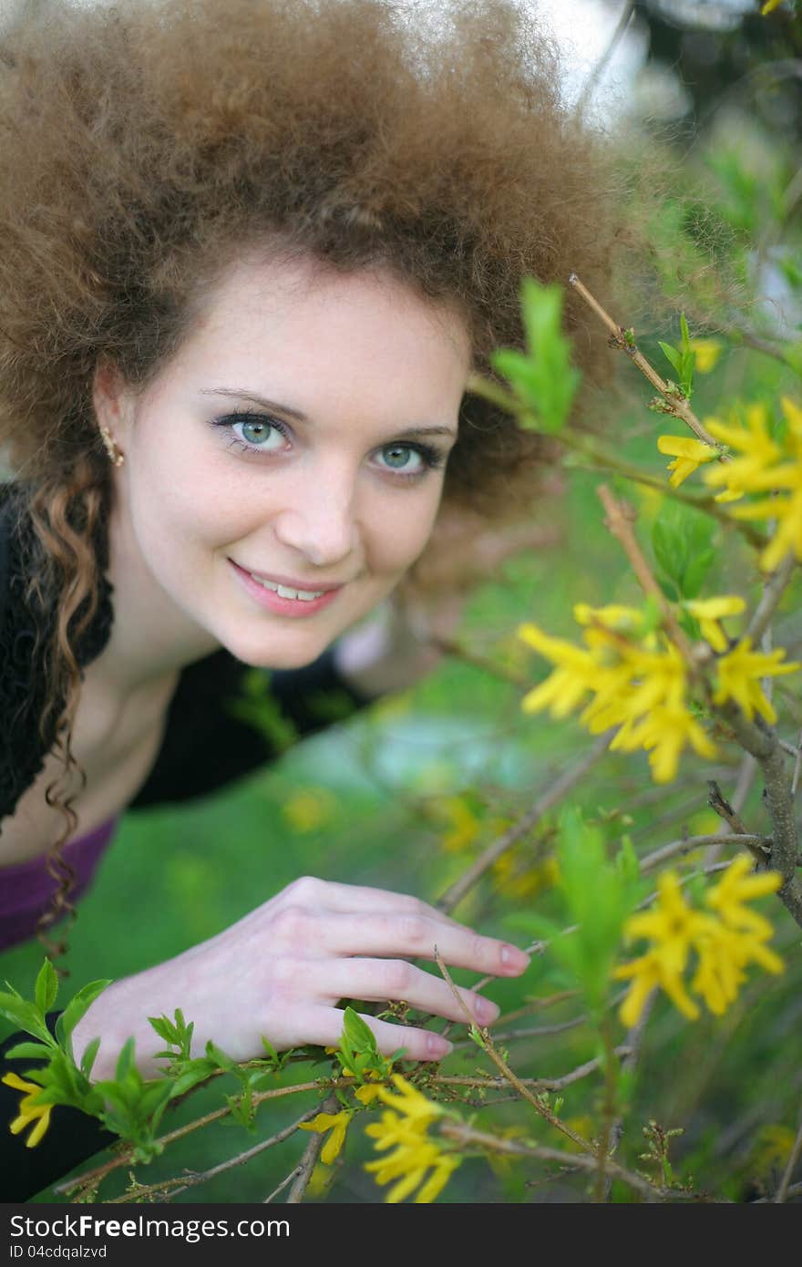 Portrait of smiling girl outdoors with yellow flowers