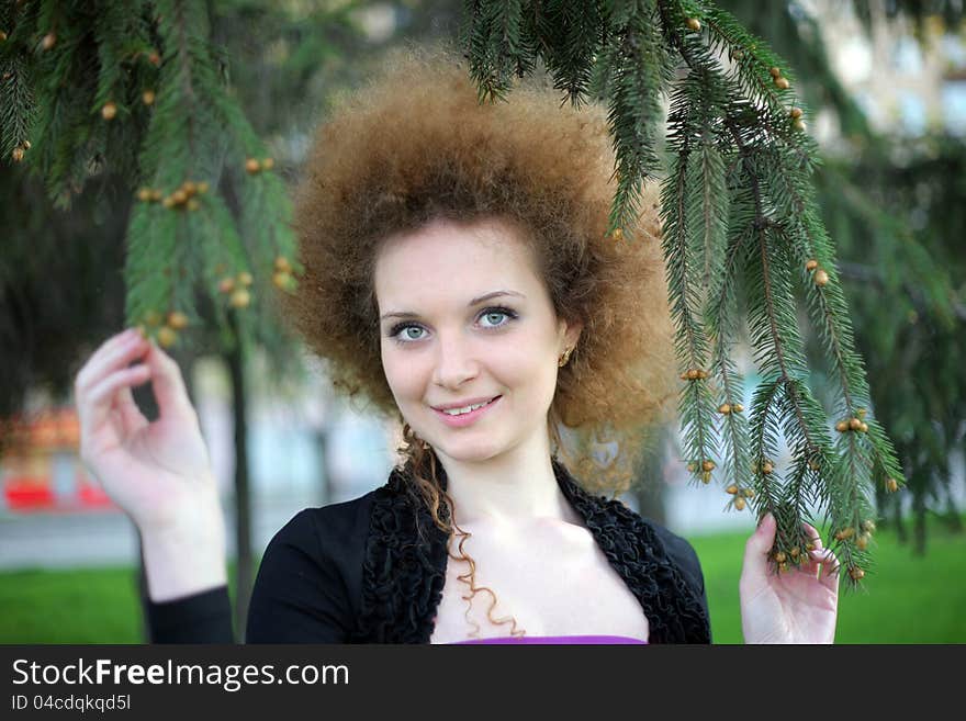 Portrait of a smiling girl in pine trees summer