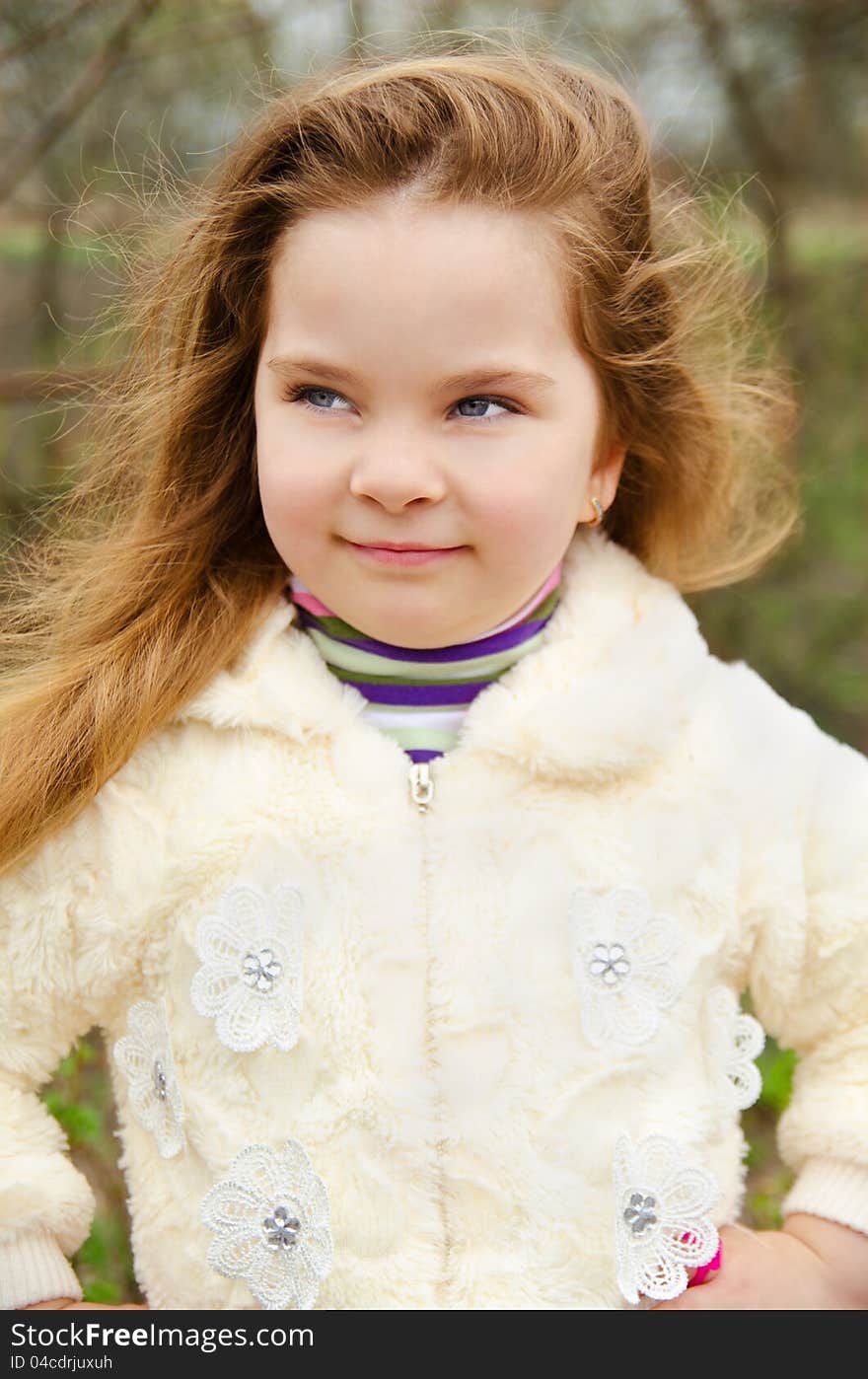 Portrait of smiling cute little girl outdoors on a spring day. Portrait of smiling cute little girl outdoors on a spring day