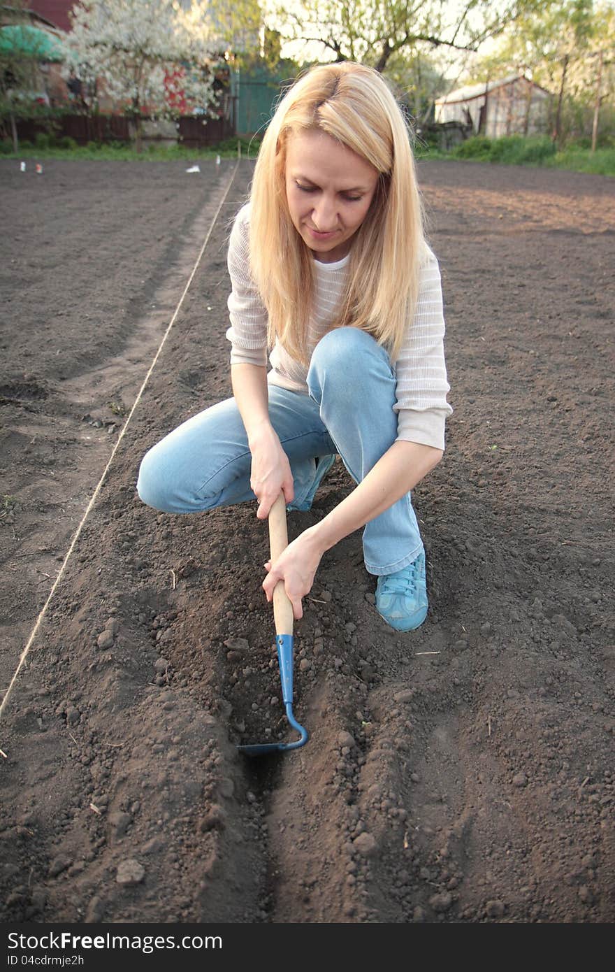 A Woman Working In Garden