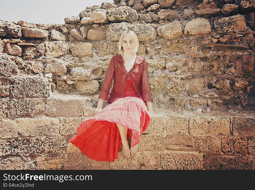 Girl in red sitting on the wall