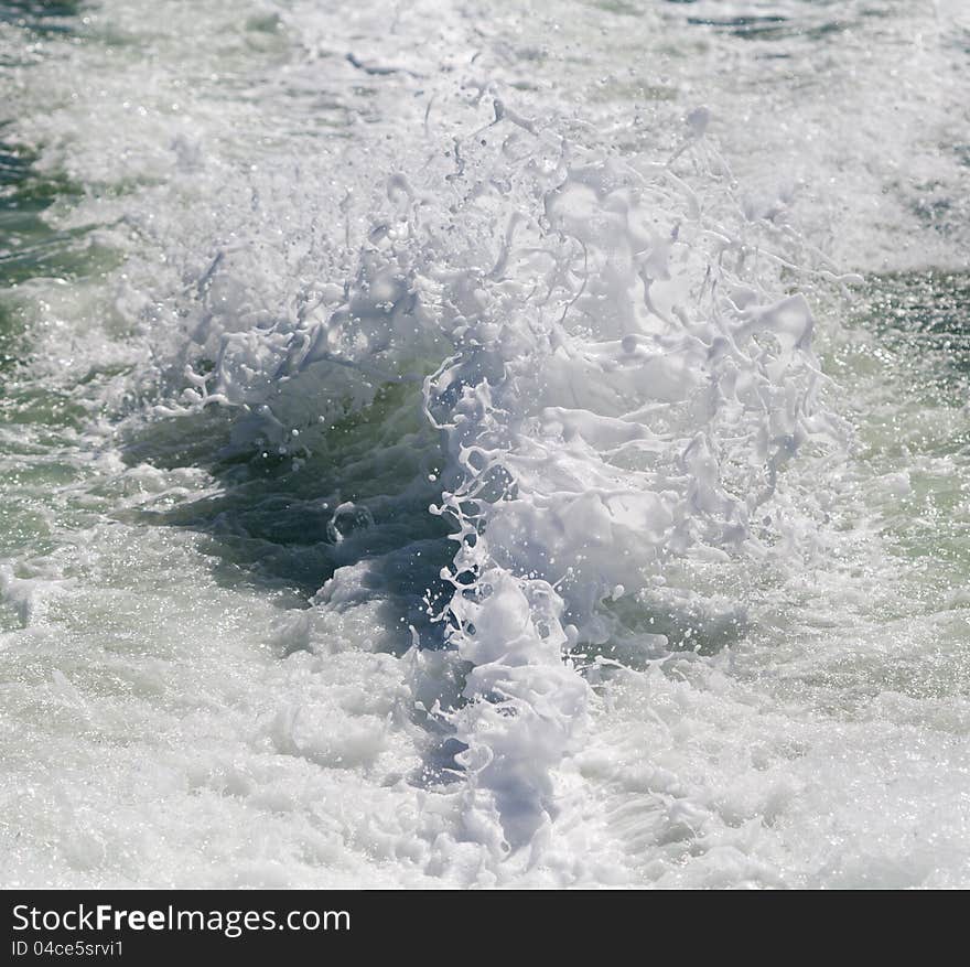 Foam from the wake of a ship out to sea. Foam from the wake of a ship out to sea