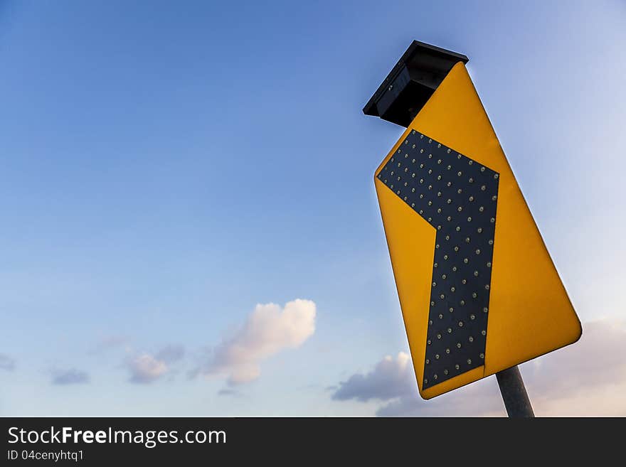 Yellow traffic label in blue sky