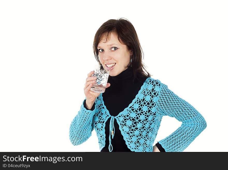 Beautiful happy girl drinks water from a glass