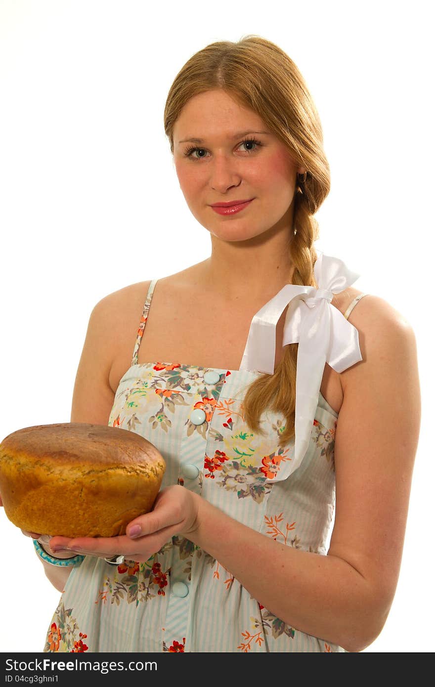 A young girl with fresh bread in the hands of