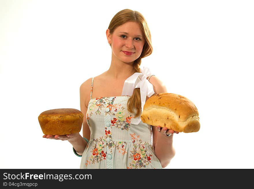 A young girl with fresh bread in the hands of