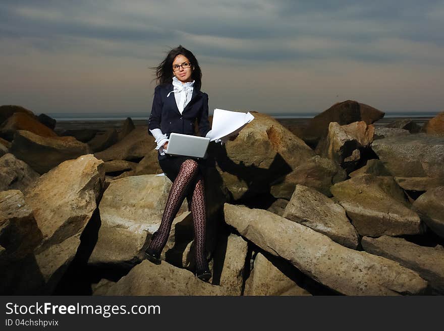 Business Lady Sitting On The Rocks By The Sea, Aga