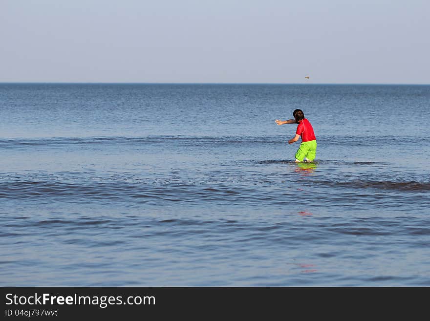 Boy standing in the ocean