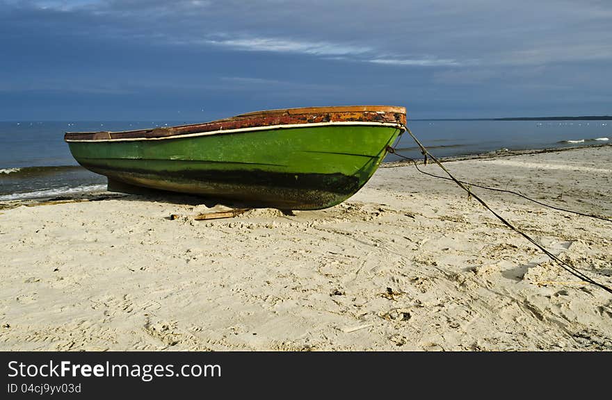 The old fishing boat was photographed at early morning on the beach of Baltic Sea, Latvia, Europe