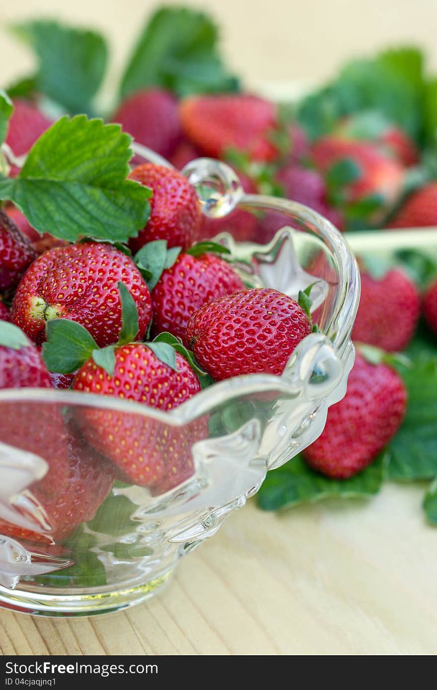 Glass bowl full of ripe and delicious strawberries. Glass bowl full of ripe and delicious strawberries