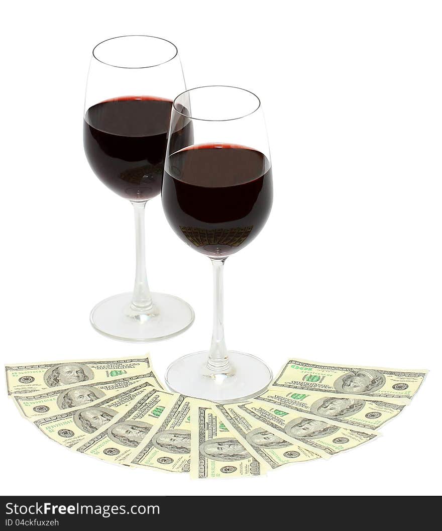 Glasses fill with red wine and money isolated on a white background