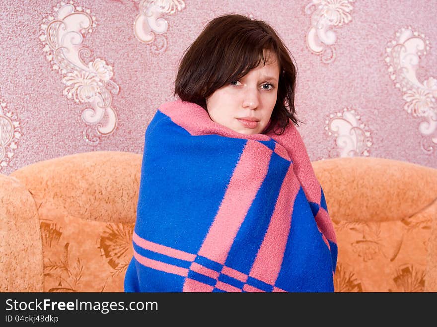 Girl wrapped in a blanket on the couch. Girl wrapped in a blanket on the couch