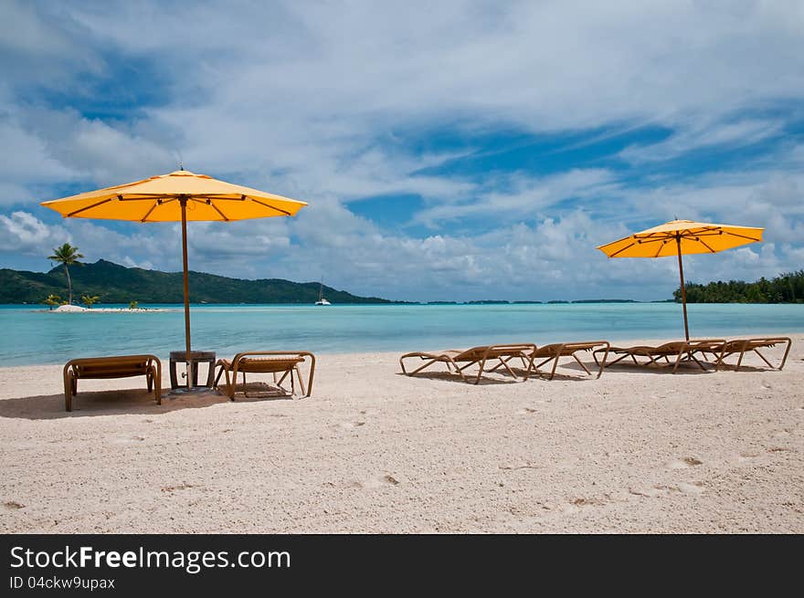 Nice beach with chairs and umbrellas in the amazing lagoon in French Polynesia. Nice beach with chairs and umbrellas in the amazing lagoon in French Polynesia