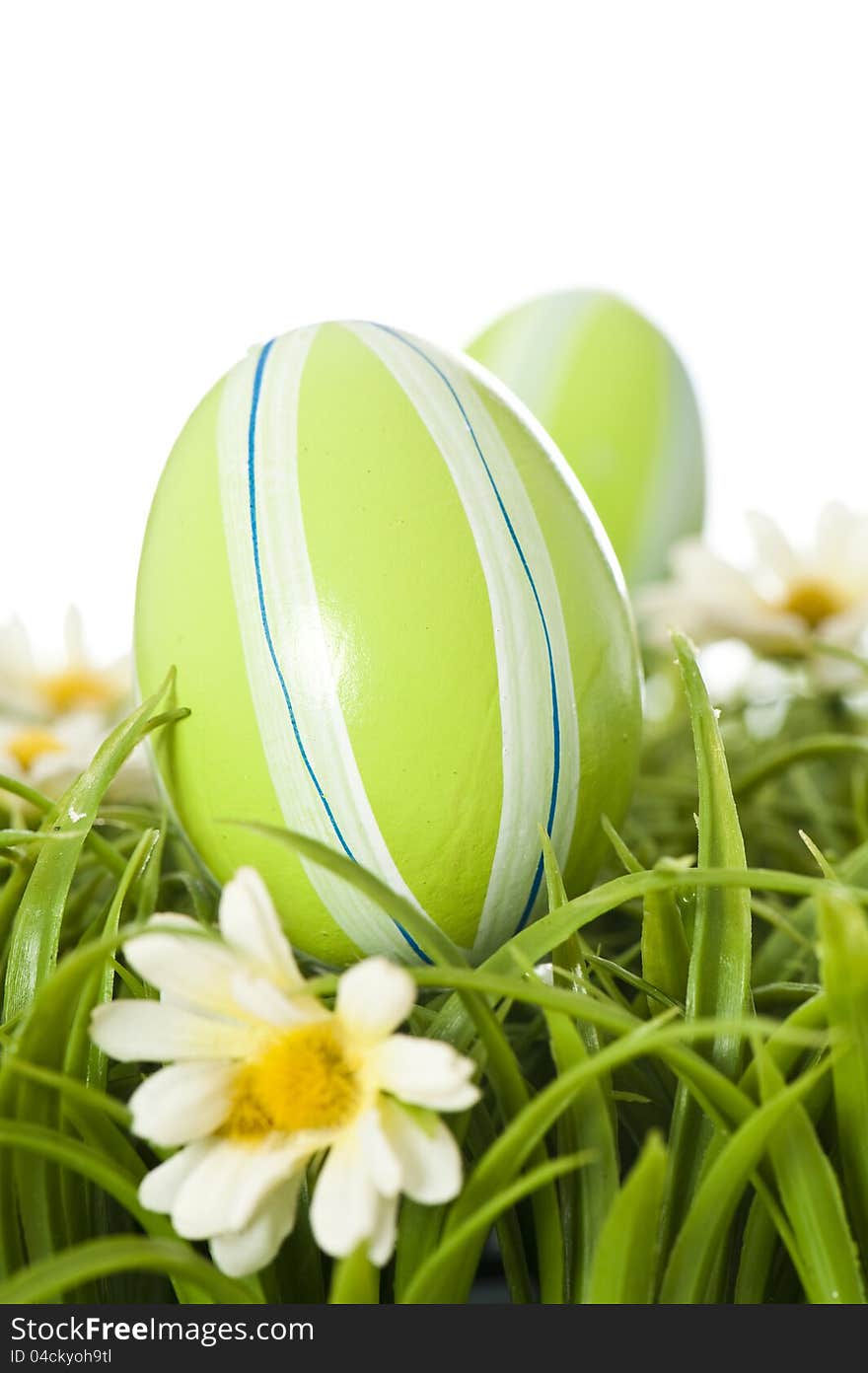 Easter eggs on grass isolated on white