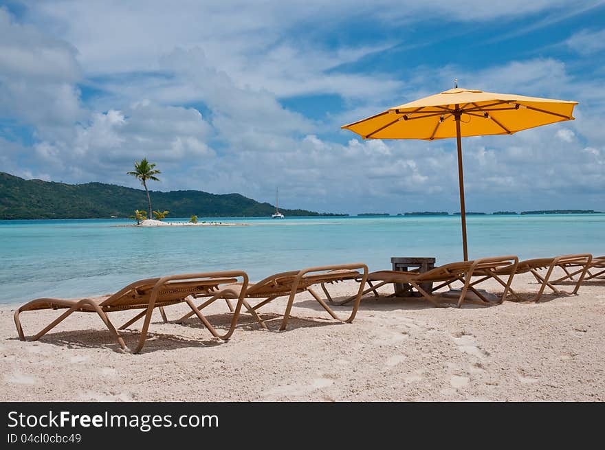 Nice beach with chairs and umbrella in the Polynesia. Nice beach with chairs and umbrella in the Polynesia