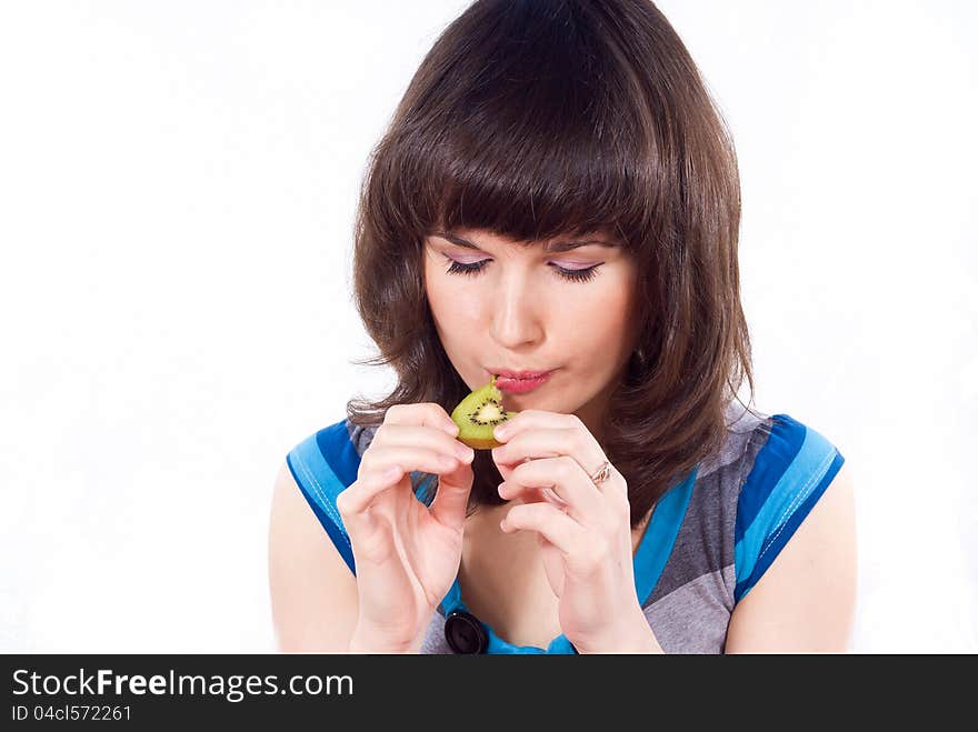 Happy girl eats kiwi isolated. Happy girl eats kiwi isolated