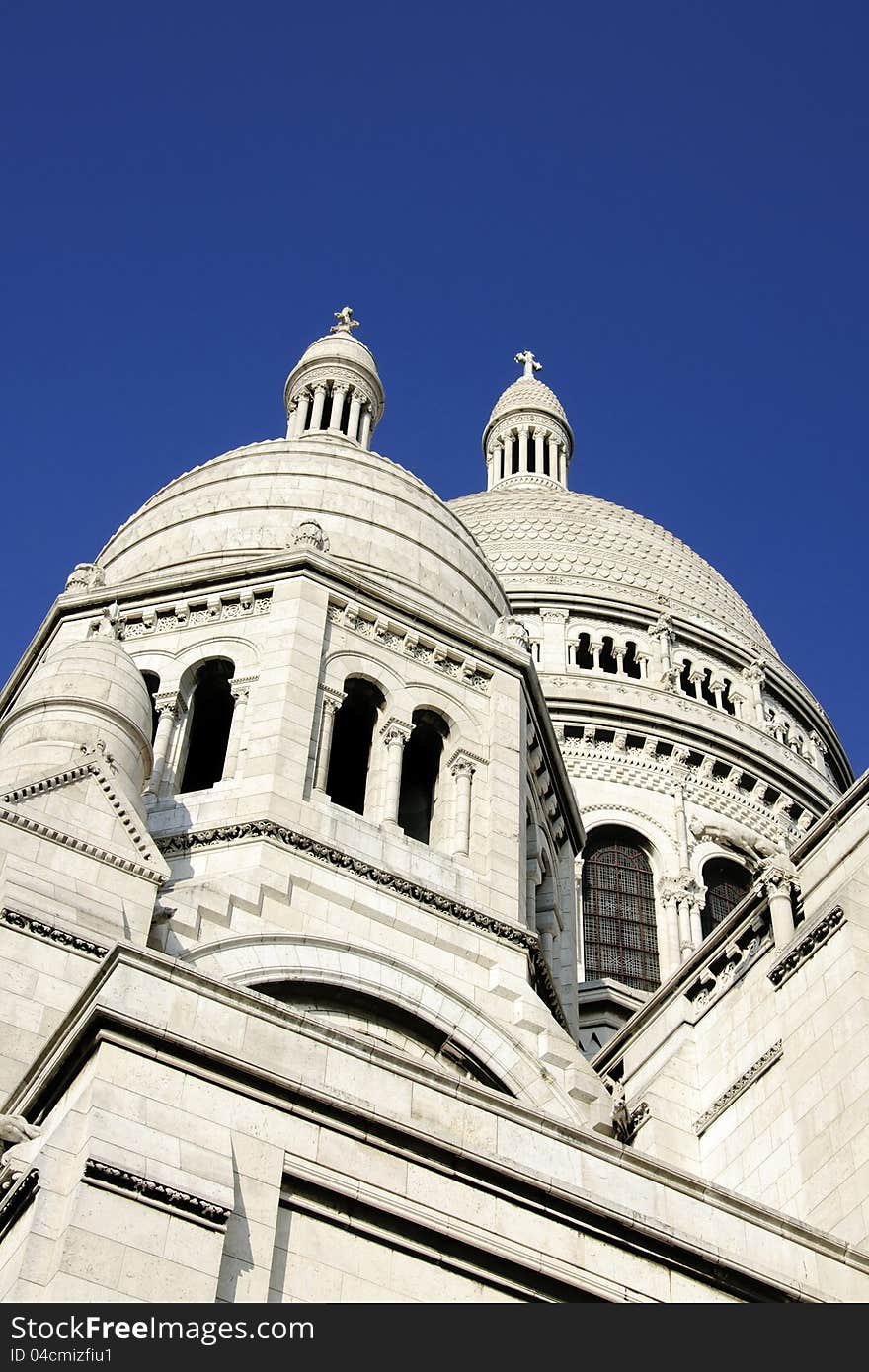 Domes of the Sacre Coeur Basilica in Montmartre, Paris over a deep blue sky. Domes of the Sacre Coeur Basilica in Montmartre, Paris over a deep blue sky