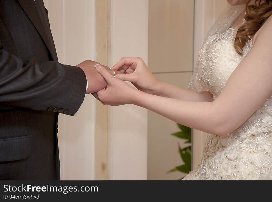 The bride puts on a ring to the groom