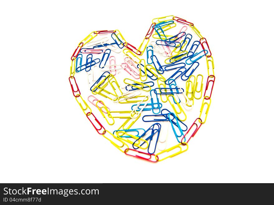 Heart of paper clips on white