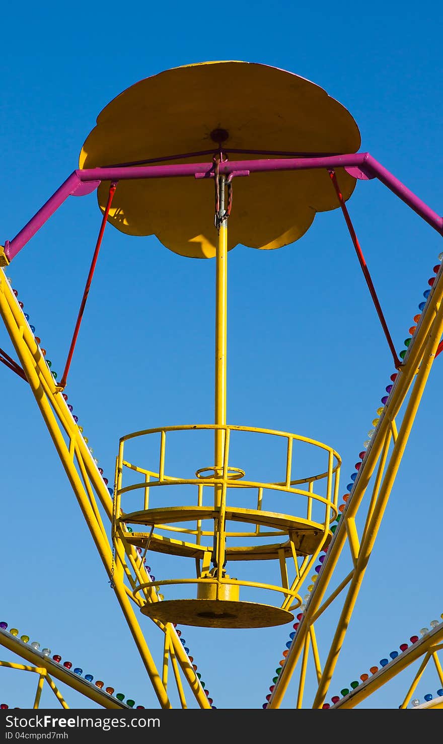 Abandoned empty roundabout on clear blue sky