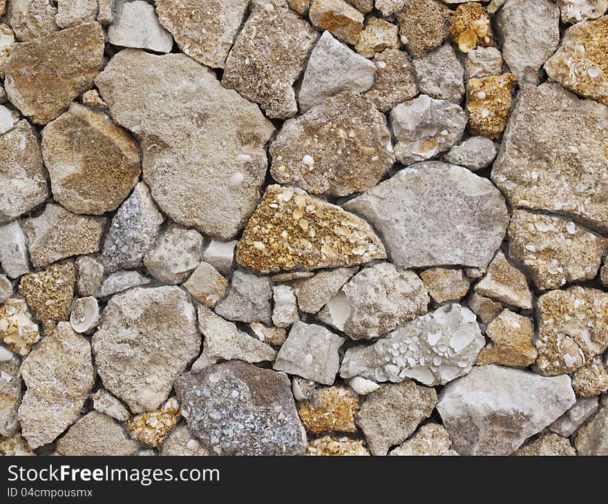 Fence of a natural building material of a yellow shell rock. Fence of a natural building material of a yellow shell rock