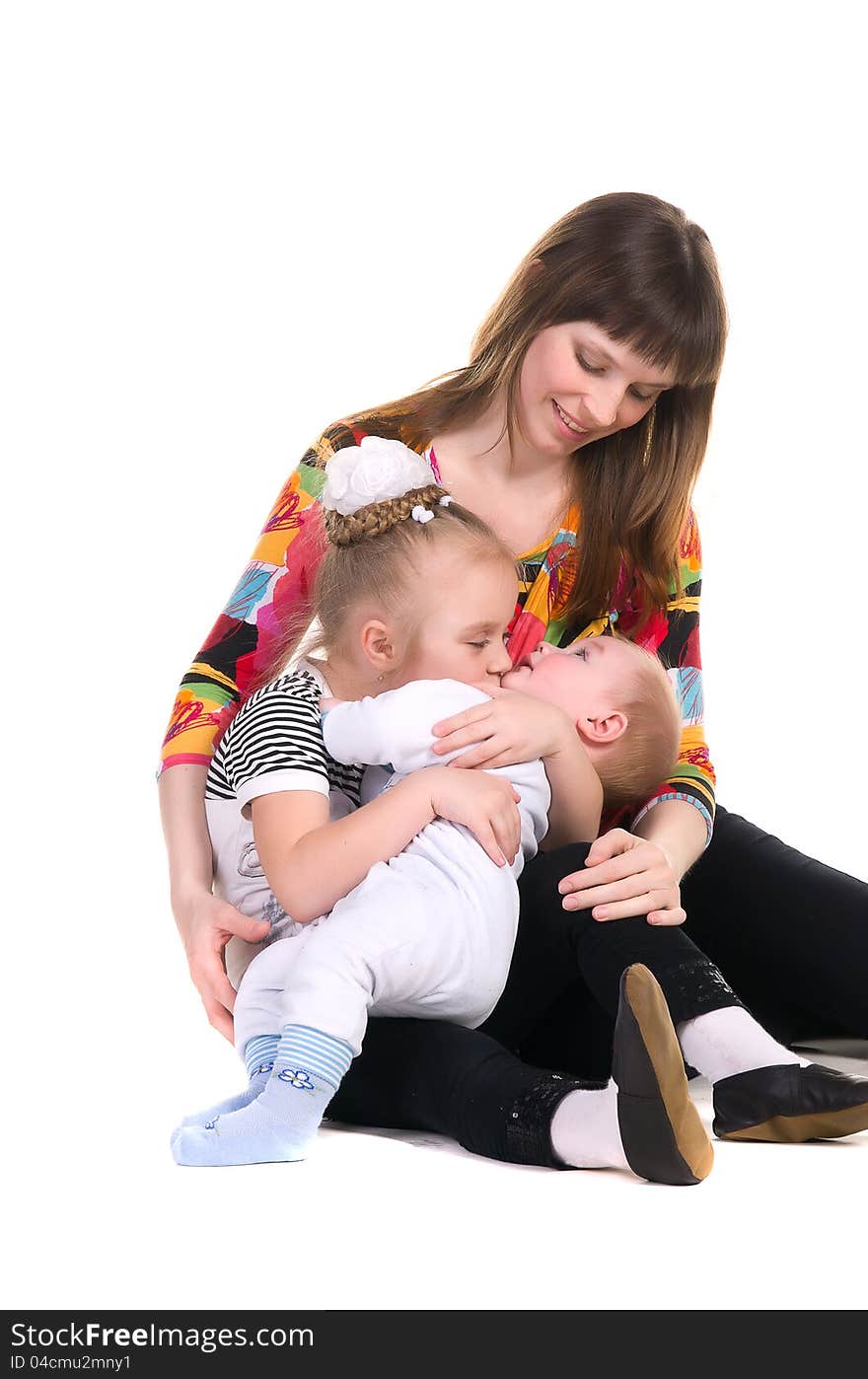 Family portrait, a women looks at her children, sister kisses baby brother, isolated on white background. Family portrait, a women looks at her children, sister kisses baby brother, isolated on white background